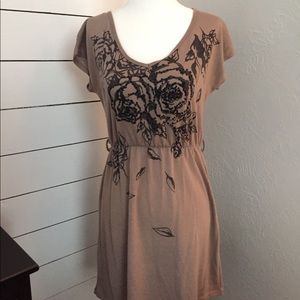 Tan dress with black flower embellishments